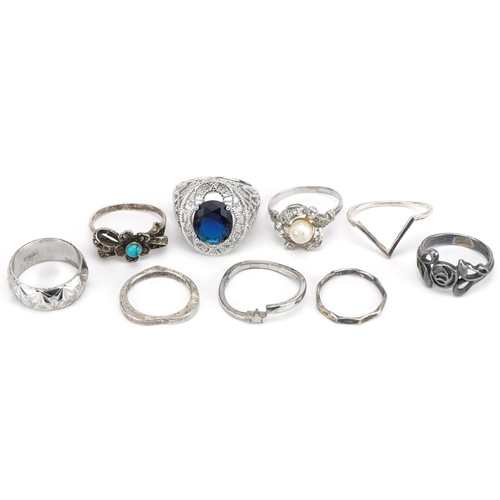 3703 - Nine silver and white metal rings including one set with a solitaire blue stone, cabochon turquiose ... 