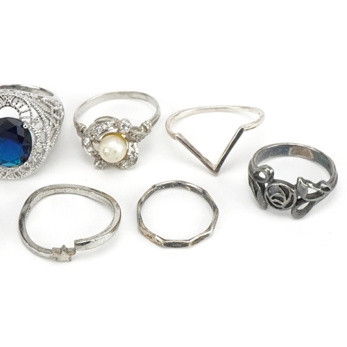 3703 - Nine silver and white metal rings including one set with a solitaire blue stone, cabochon turquiose ... 