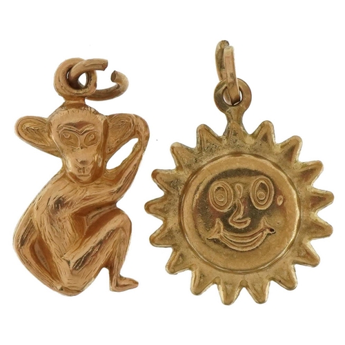 3557 - Two 9ct gold charms comprising monkey and smiley face sun, the largest 1.8cm high, total 2.3g