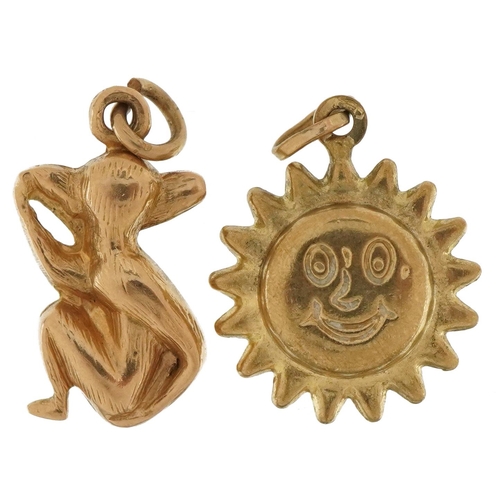 3557 - Two 9ct gold charms comprising monkey and smiley face sun, the largest 1.8cm high, total 2.3g