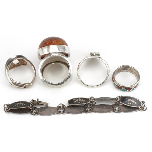 3613 - Silver jewellery comprising large natural amber ring, three other rings and a Siam silver bracelet, ... 