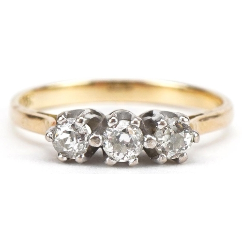 3011 - Unmarked gold diamond three stone ring, tests as 18ct gold, total diamond weight approximately 0.25 ... 