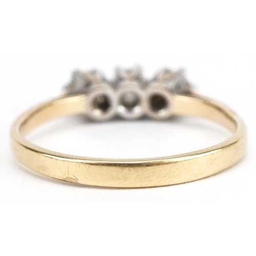 3011 - Unmarked gold diamond three stone ring, tests as 18ct gold, total diamond weight approximately 0.25 ... 