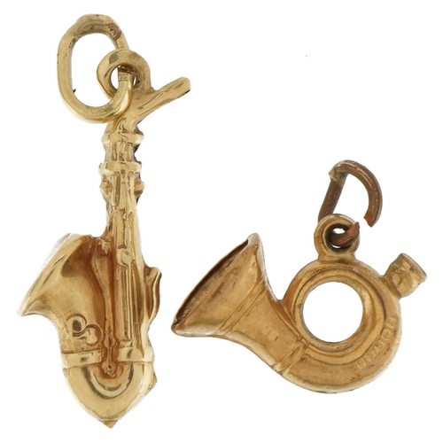 3682 - Two 9ct gold musical instrument charms comprising French horn and saxophone, the largest 2.4cm high,... 