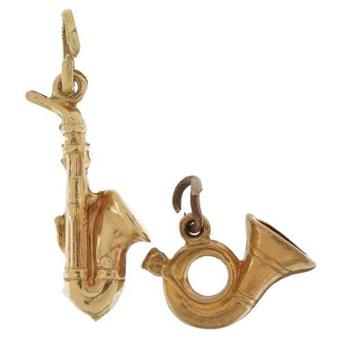 3682 - Two 9ct gold musical instrument charms comprising French horn and saxophone, the largest 2.4cm high,... 