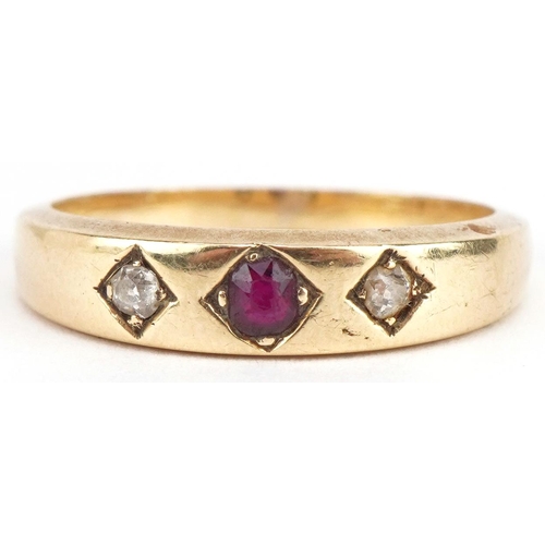 3165 - Unmarked gold garnet and diamond three stone ring, tests as 18ct gold, size Q, 4.6g