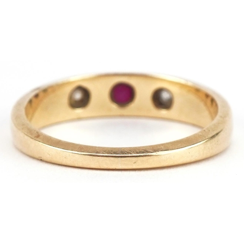 3165 - Unmarked gold garnet and diamond three stone ring, tests as 18ct gold, size Q, 4.6g