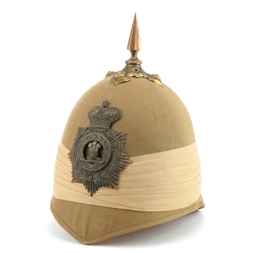 455 - Victorian military interest pith spike top type helmet with Welsh helmet badge housed in a tin case,... 