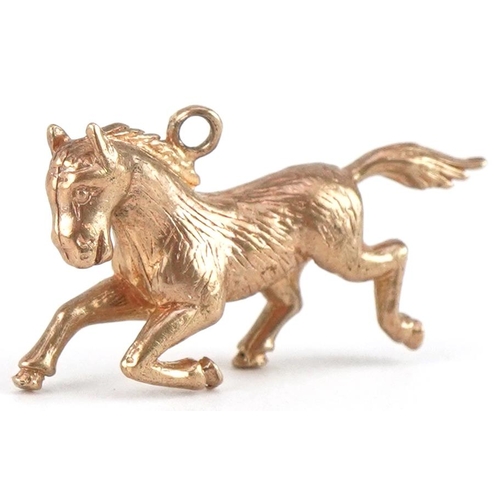 3430 - 9ct gold galloping horse charm, 2.1cm in length, 2.5g