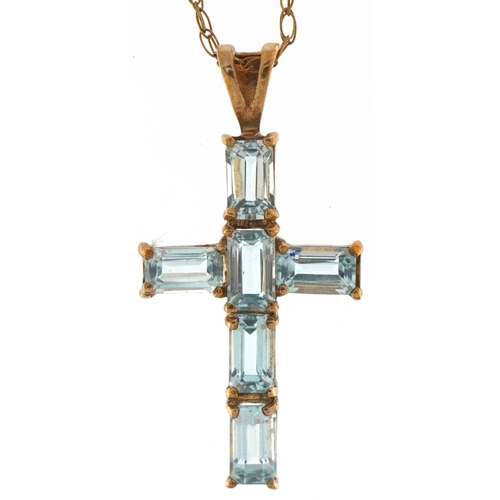 3337 - 9ct gold blue topaz cross pendant on a 9ct gold necklace, 2.8cm high and 44cm in length, 2.1g