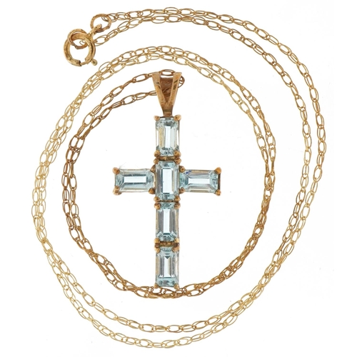 3337 - 9ct gold blue topaz cross pendant on a 9ct gold necklace, 2.8cm high and 44cm in length, 2.1g