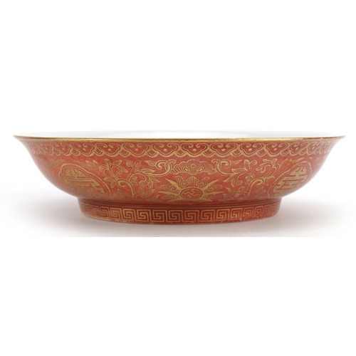 527 - Chinese porcelain iron red ground dish gilded with flower heads amongst scrolling foliage, six figur... 