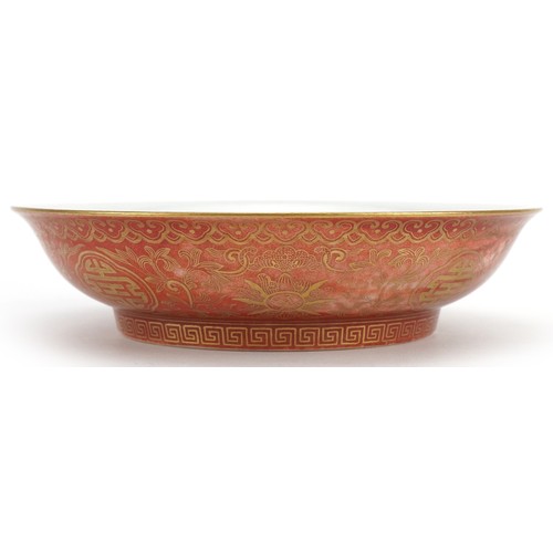 527 - Chinese porcelain iron red ground dish gilded with flower heads amongst scrolling foliage, six figur... 