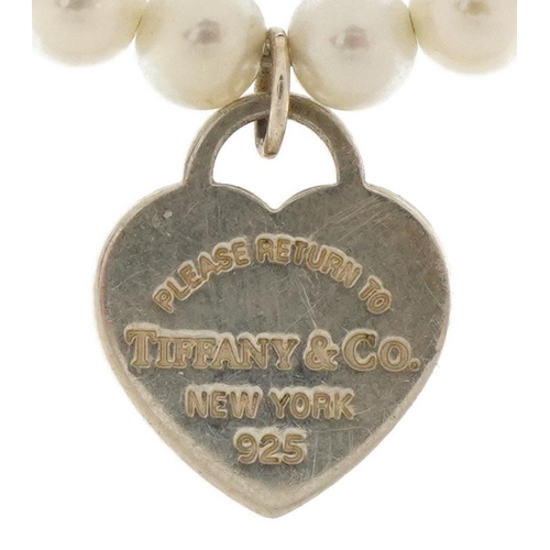 3659 - Tiffany & Co, cultured pearl and silver bracelet with love heart charm, 16cm in length, 4.6g