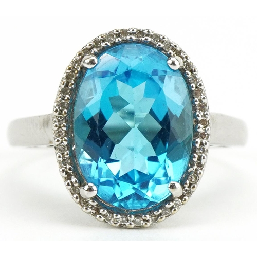 3088 - Large 9ct white gold blue topaz and diamond ring with pierced shoulders, the topaz approximately 14.... 