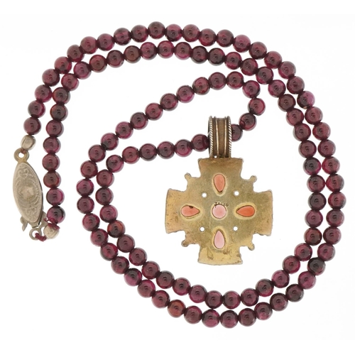 3500 - Silver gilt garnet and seed pearl pendant on a garnet bead necklace, 3.2cm high and 48cm in length, ... 