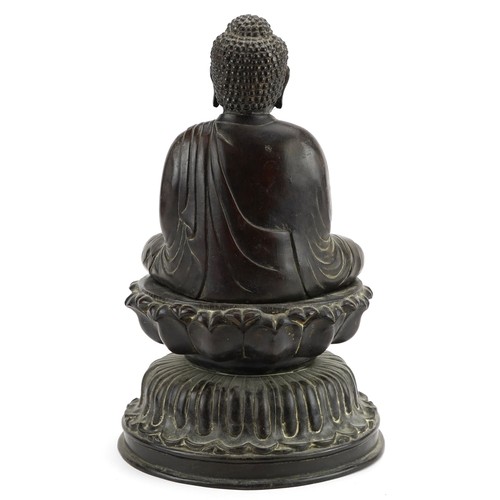 69 - Large Chinese patinated bronze figure of Shakyamuni Buddha on lotus stand, 37cm high