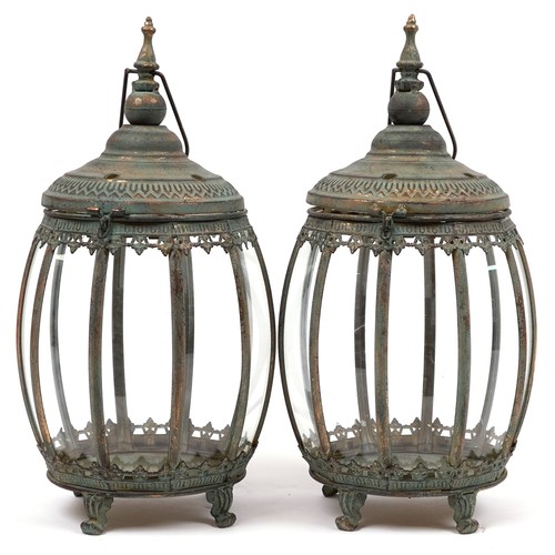 2560 - Pair of bronzed hanging lanterns with glass panels on paw feet, each 48.5cm high