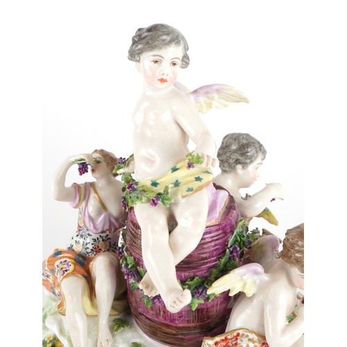 243 - Manner of Meissen, 19th century porcelain 'Vintner' centrepiece modelled in the form of three Putti ... 