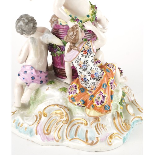 243 - Manner of Meissen, 19th century porcelain 'Vintner' centrepiece modelled in the form of three Putti ... 