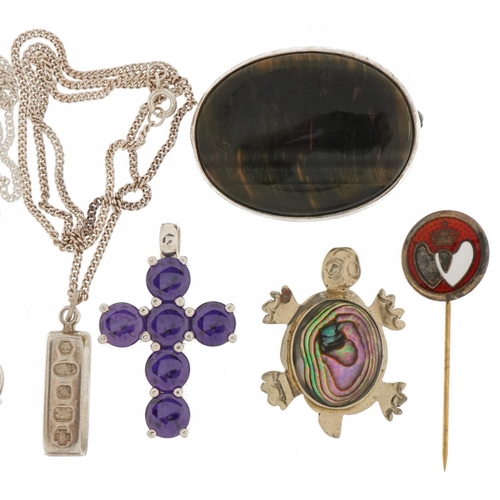 3535 - Silver and white metal jewellery including oval tiger's eye brooch, lockets, purple stone cross pend... 