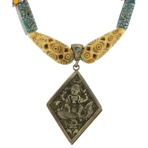 3561 - Italian millefiori glass necklace with carved bone beads and Tibetan silver locket embossed with a d... 