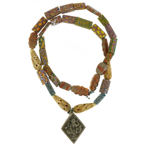 3561 - Italian millefiori glass necklace with carved bone beads and Tibetan silver locket embossed with a d... 