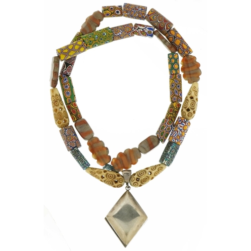 3561 - Italian millefiori glass necklace with carved bone beads and Tibetan silver locket embossed with a d... 