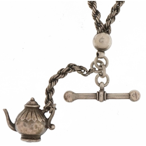 3677 - Victorian silver watch chain with T bar, dog clip clasp and a Victorian teapot charm, 26cm in length... 