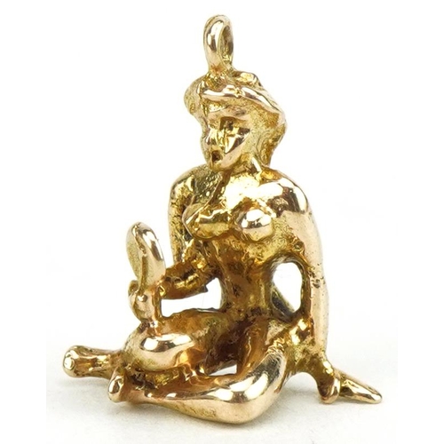 3492 - 9ct gold nude female with a hand mirror charm, 1.5cm high, 1.7g