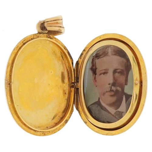 3078 - Antique unmarked gold locket with hinged interior, tests as 9ct gold, 4.7cm high, 21.8g