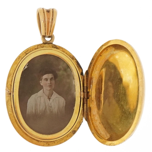 3078 - Antique unmarked gold locket with hinged interior, tests as 9ct gold, 4.7cm high, 21.8g