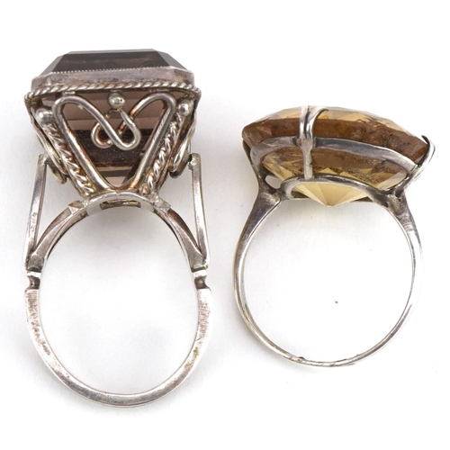 3578 - Two large silver smoky quartz and citrine rings, the citrine approximately 21mm in diameter, both si... 