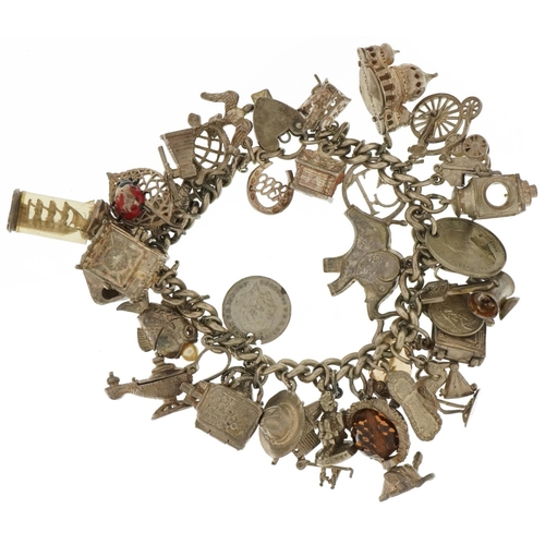 3547 - Heavy silver charm bracelet with a large selection of mostly silver charms including stork with new ... 