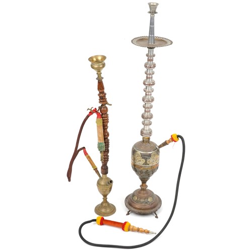 1319 - Two Islamic floor standing shisha pipes including a white metal example, the largest 118cm high