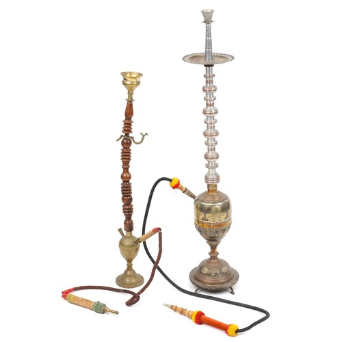 1319 - Two Islamic floor standing shisha pipes including a white metal example, the largest 118cm high