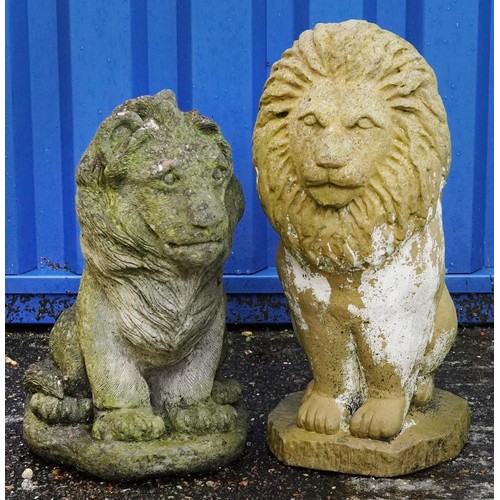 2215 - Two garden stoneware seated lions, the largest 50cm high