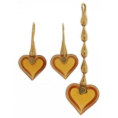 3167 - Lalique, French amber crystal love heart pendant and earrings with gold plated mounts with box, the ... 