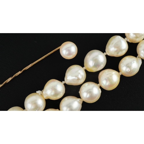 3543 - Single row Baroque pearl necklace and a cultured pearl stickpin housed in an Octee & Son case, the n... 