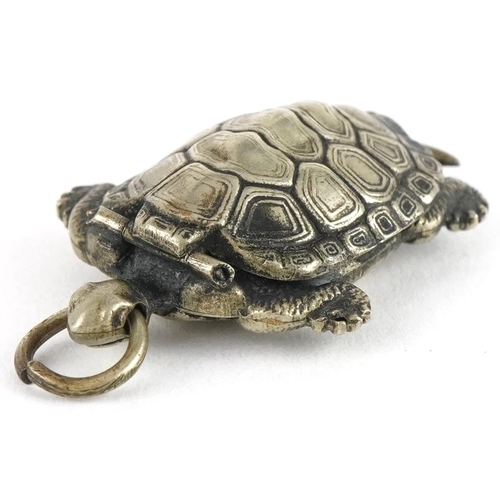 2672 - Unmarked silver tortoise pendant with hinged back and gilt interior, 3cm high, 2.5g