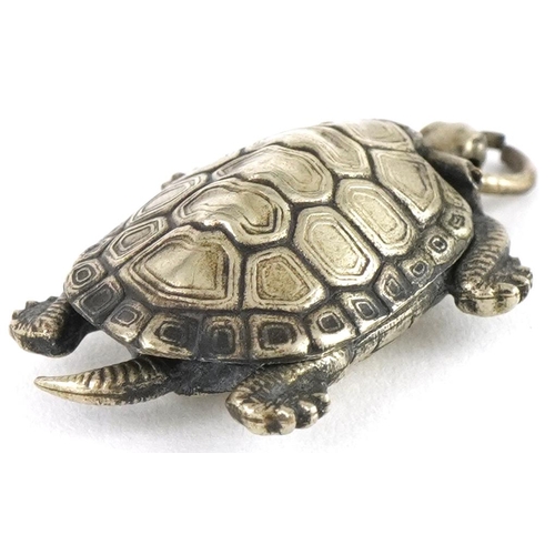 2672 - Unmarked silver tortoise pendant with hinged back and gilt interior, 3cm high, 2.5g