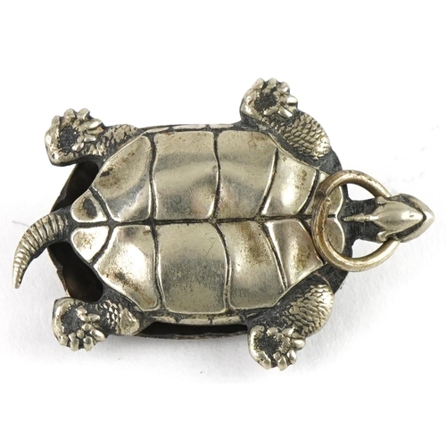 2672 - Unmarked silver tortoise pendant with hinged back and gilt interior, 3cm high, 2.5g