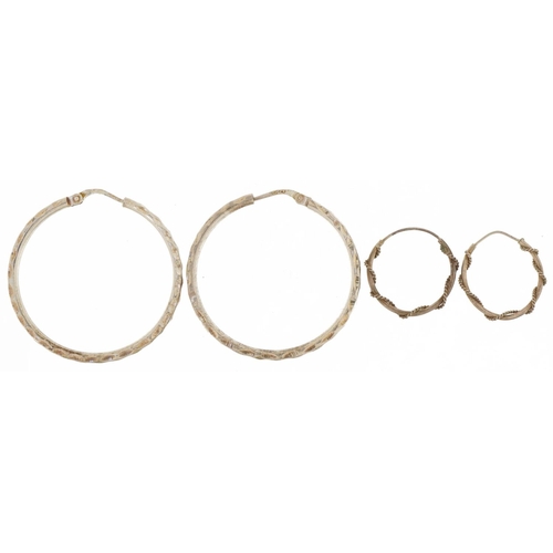 2827 - Two pairs of silver hoop earrings including one pair engine turned, the largest 3.5cm in diameter, t... 