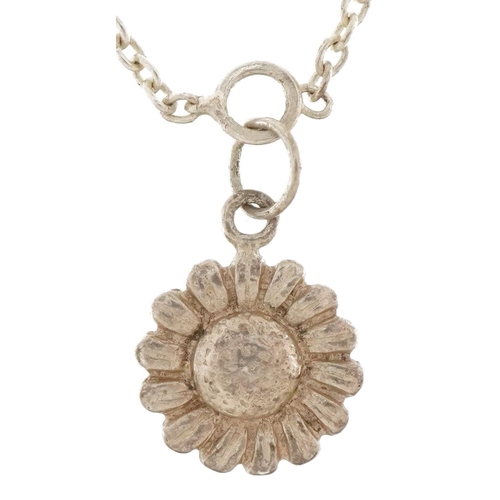 2802 - Unmarked silver flower head pendant on a silver chain link necklace, 1.3cm high and 80cm in length, ... 