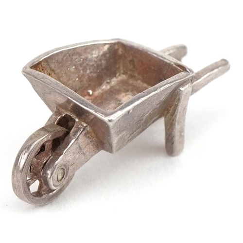 2749 - Unmarked silver wheelbarrow charm, 2.1cm in length, 2.5g