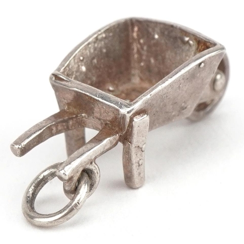 2749 - Unmarked silver wheelbarrow charm, 2.1cm in length, 2.5g