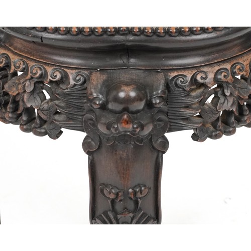 2060 - Chinese hardwood stand with inset marble top, carved and pierced with mythical heads and gourds on c... 