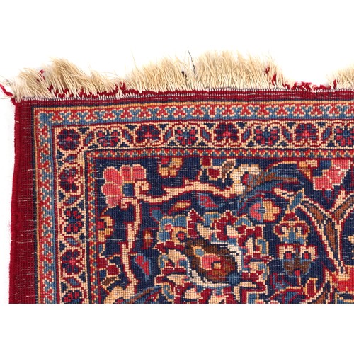 2182 - Rectangular Persian Sarouk type part silk red ground rug having an allover floral design, 214cm x 13... 