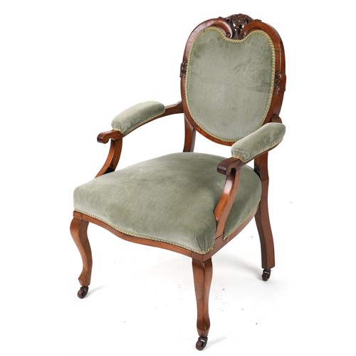 2135 - Victorian style armchair with olive green upholstery on cabriole legs with casters, 95cm high