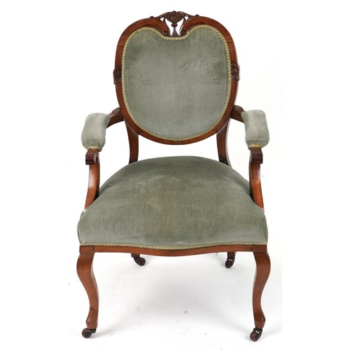 2135 - Victorian style armchair with olive green upholstery on cabriole legs with casters, 95cm high